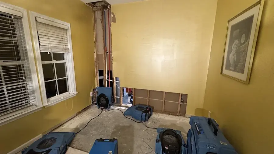 Air movers drying a room after a wall was opened in Rowan County