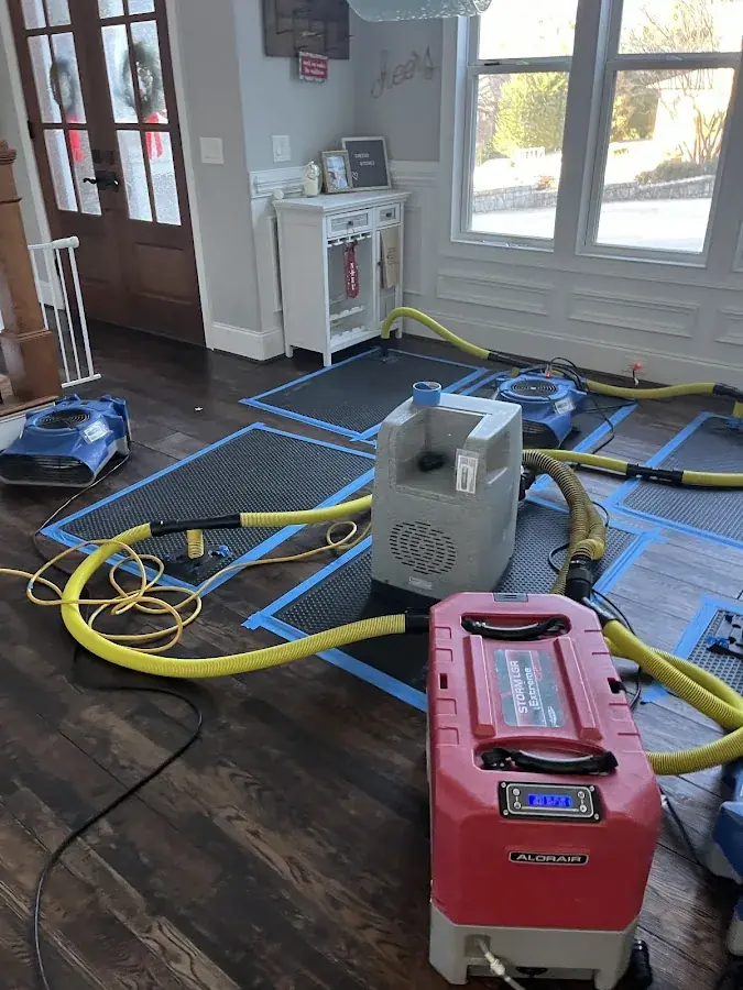 Drying gear staged across a water damaged room in Rowan County