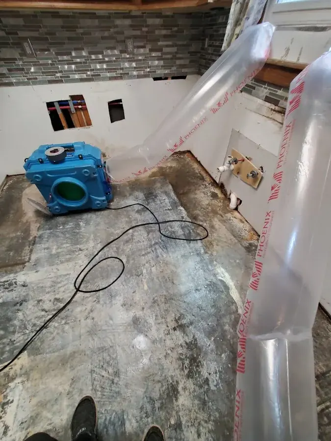Wet kitchen flooring pulled up for drying in Rowan County